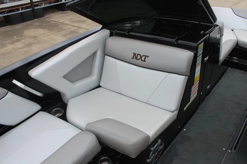 Slide: The Image of 2017 MasterCraft NXT22 boat interior with gray seating and cup holders. - 15