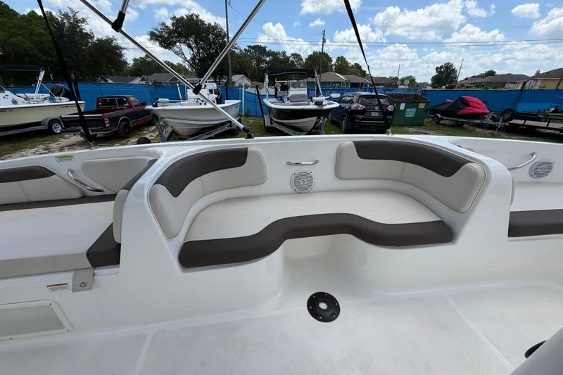 Slide: The Image of 2023 Bayliner Element E18 boat interior with cushioned seating and speakers. - 8
