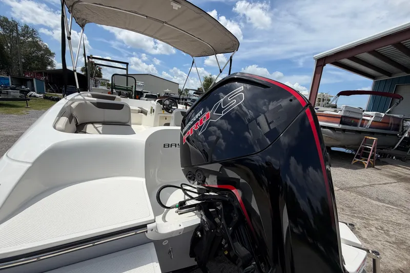 Slide: The Image of 2023 Bayliner Element E18 boat with Mercury Pro XS engine, docked under a sunny sky. - 3