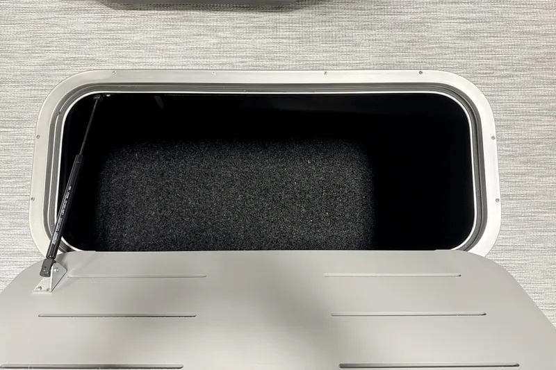 Slide: The Image of Storage compartment of 2026 Bennington 22 S-One Swingback boat, open with visible interior. - 17