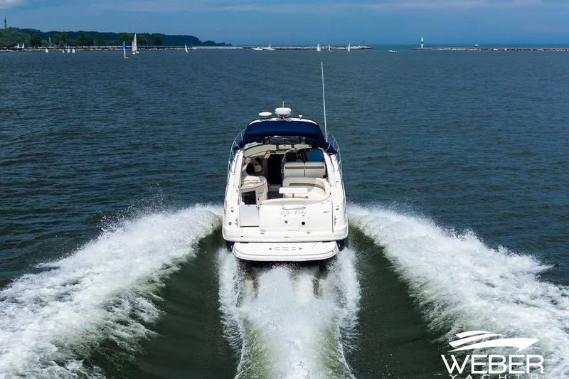 Slide: The Image of 2004 Sea Ray Sundancer 320 cruising on open water, leaving a wake behind. - 34