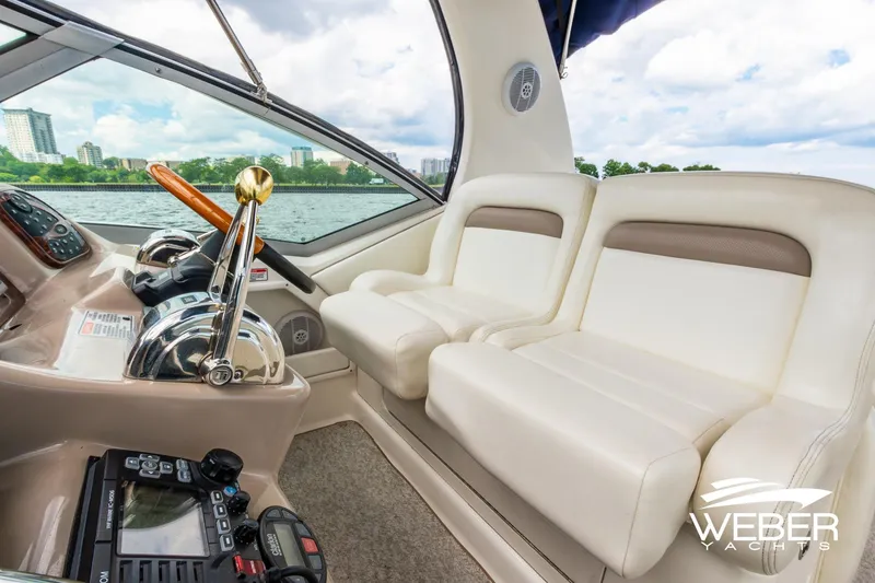 Slide: The Image of Interior of 2004 Sea Ray Sundancer 320 yacht with plush seating and control panel. - 9