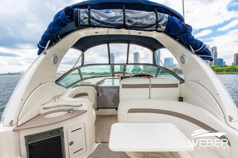 Slide: The Image of 2004 Sea Ray Sundancer 320 yacht interior with city skyline in background. - 4