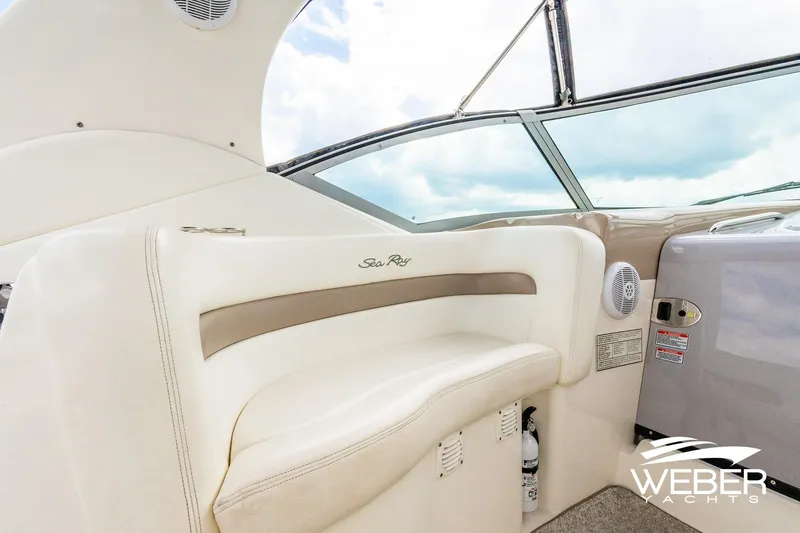 Slide: The Image of 2004 Sea Ray Sundancer 320 interior with plush seating and modern dashboard. - 8