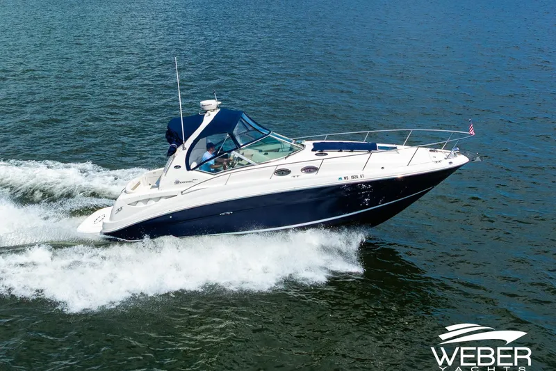 Slide: The Image of 2004 Sea Ray Sundancer 320 cruising on open water, showcasing sleek design and performance. - 3