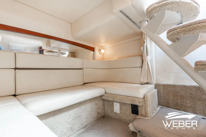 Slide: The Image of Interior of 2004 Sea Ray Sundancer 320 yacht with plush seating and carpeted stairs. - 16