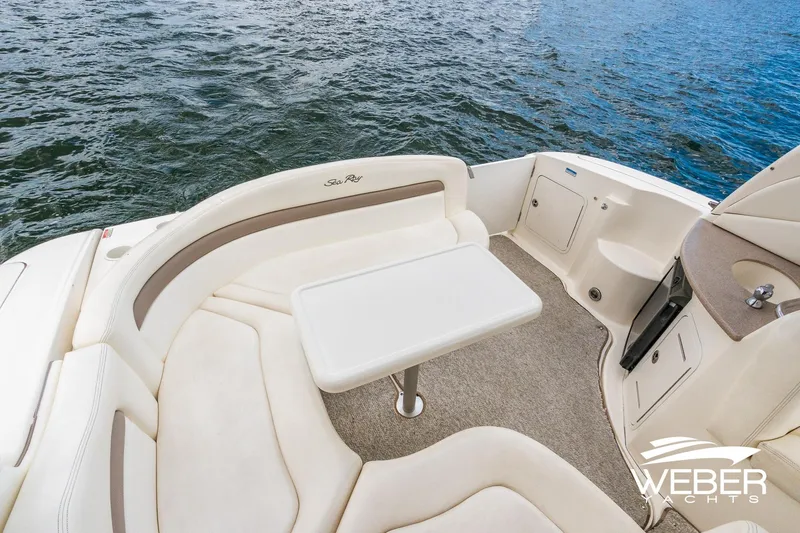 Slide: The Image of 2004 Sea Ray Sundancer 320 boat interior with seating and table, overlooking water. - 6