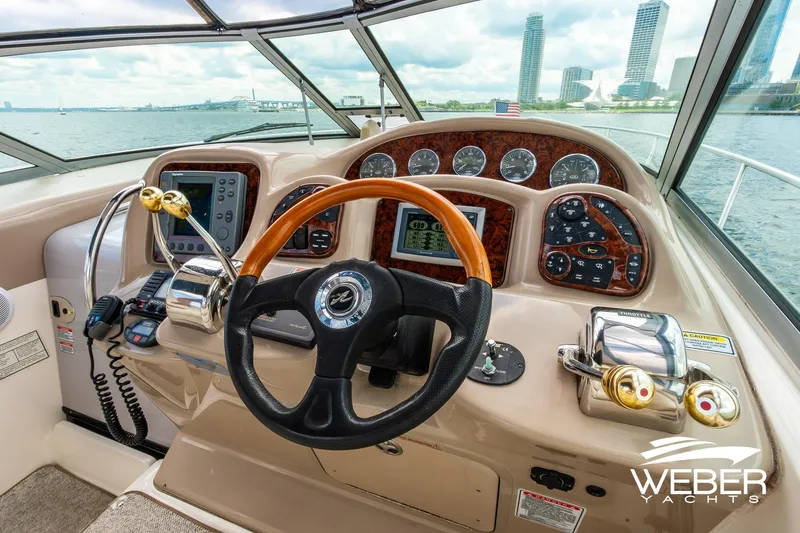 Slide: The Image of Cockpit view of 2004 Sea Ray Sundancer 320 yacht with city skyline in background. - 25