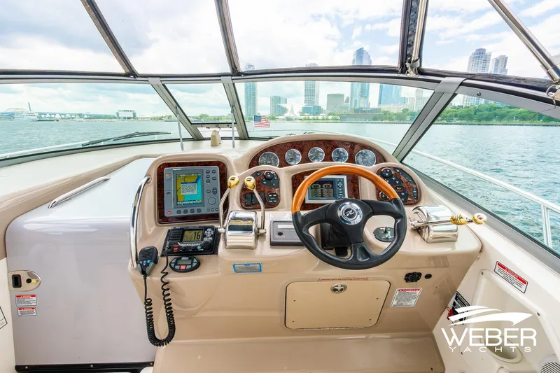 Slide: The Image of Cockpit view of 2004 Sea Ray Sundancer 320 yacht with city skyline in background. - 10