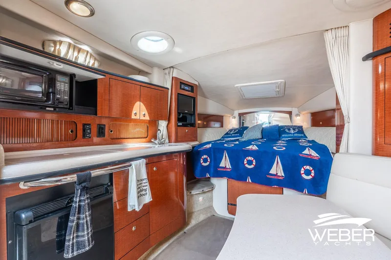 Slide: The Image of Interior of 2004 Sea Ray Sundancer 320 yacht with cozy cabin and kitchenette. - 15