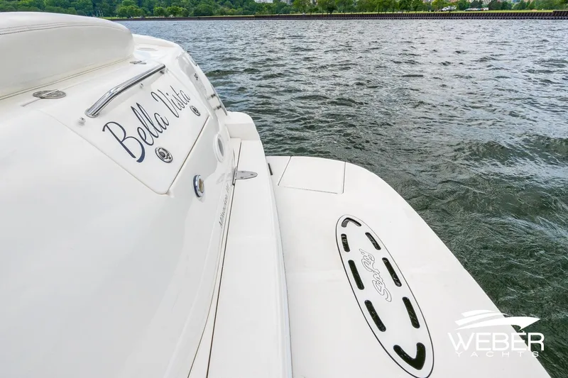 Slide: The Image of 2004 Sea Ray Sundancer 320 yacht on water, rear view with "Bella Vista" name. - 21