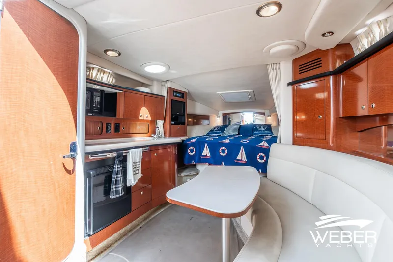 Slide: The Image of Interior of 2004 Sea Ray Sundancer 320 yacht with kitchen and cozy seating area. - 14