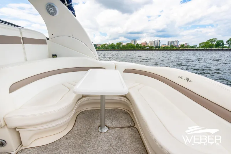 Slide: The Image of Luxurious seating area on a 2004 Sea Ray Sundancer 320 yacht, overlooking a scenic waterfront. - 5