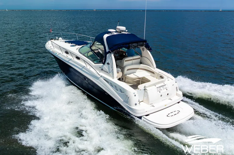 Slide: The Image of 2004 Sea Ray Sundancer 320 cruising on open water, showcasing sleek design and performance. - 32