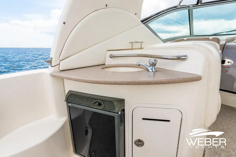 Slide: The Image of 2004 Sea Ray Sundancer 320 yacht interior with sink and storage, ocean view. - 7