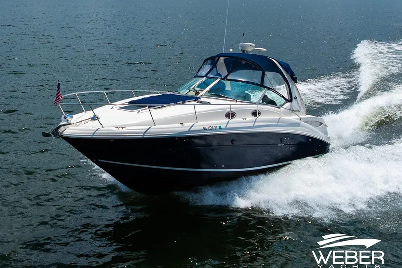 Slide: The Image of 2004 Sea Ray Sundancer 320 cruising on open water, showcasing sleek design and performance. - 33