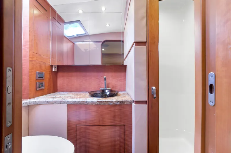 Slide: The Image of Interior of a modern boat cabin with wood paneling, sink, and shower. - 48