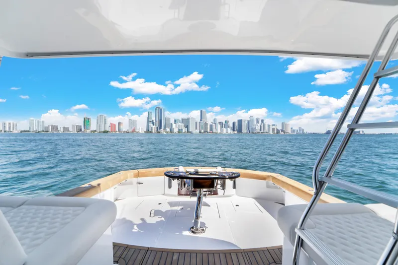 Slide: The Image of A 2022 Garlington Convertible with a view of a city skyline over water, blue sky, and clouds. - 32