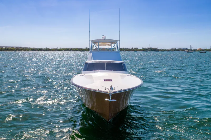 Slide: The Image of A 2022 Garlington Convertible cruising on open water with a clear sky in the background. - 10