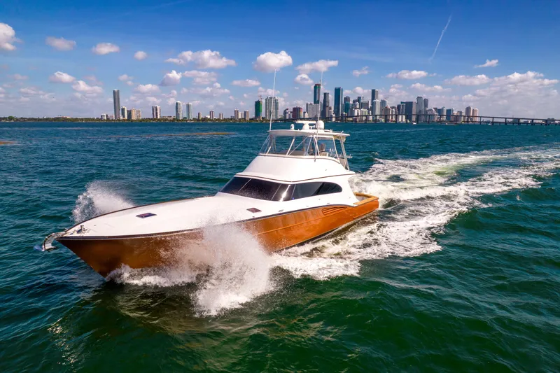 Slide: The Image of 2022 Garlington Convertible cruising on the water with a city skyline in the background. - 25