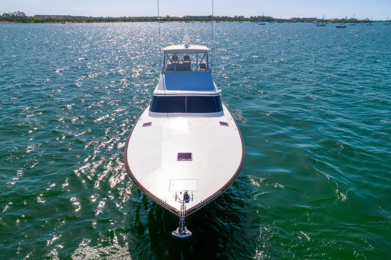 Slide: The Image of A sleek 2022 Garlington Convertible boat glides over sparkling water under sunny skies. - 11