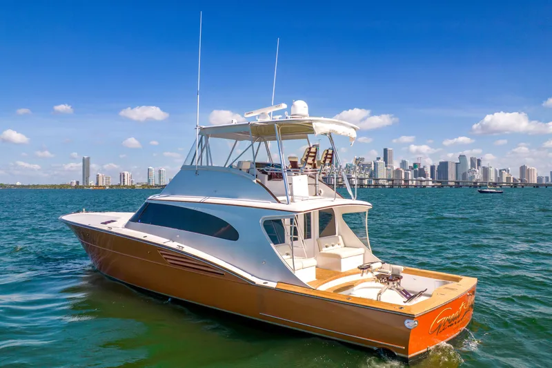 Slide: The Image of Garlington Convertible 2022 on the water with city skyline in the background. - 3