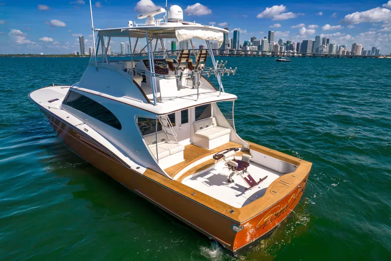 Slide: The Image of 2022 Garlington Convertible on the water with a city skyline in the background. - 16