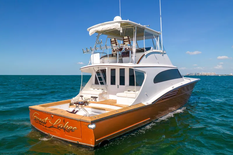 Slide: The Image of A 2022 Garlington Convertible on open water. It features a sleek design and spacious aft deck. - 5