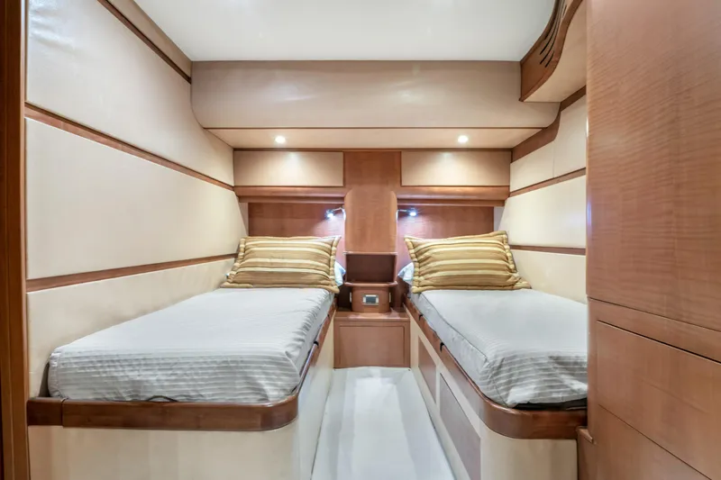 Slide: The Image of Interior of the 2022 Garlington Convertible with two single beds and wood paneling. - 46