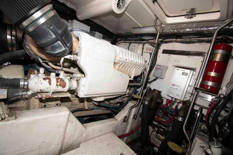 Slide: The Image of Engine room of a 2004 Tiara Yachts 4100 Open, featuring mechanical components and wiring. - 29