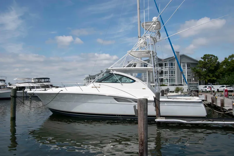 The Image of 2004 Tiara Yachts 4100 Open docked at marina, clear sky background. - 0