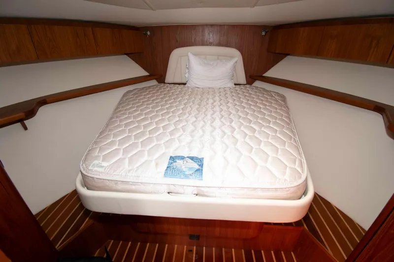 Slide: The Image of 2004 Tiara Yachts 4100 Open cabin with a comfortable bed and wooden interior. - 25