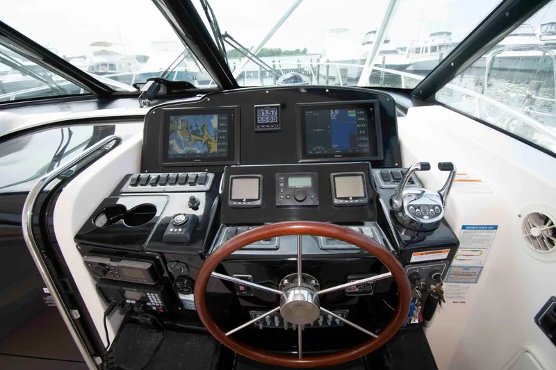 Slide: The Image of Cockpit of 2004 Tiara Yachts 4100 Open with navigation equipment and steering wheel. - 10