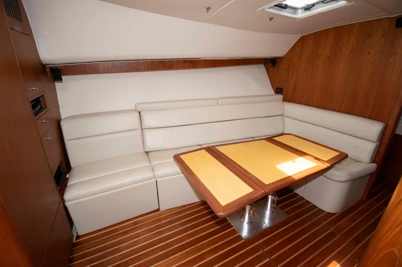 Slide: The Image of Luxurious interior of 2004 Tiara Yachts 4100 Open with elegant seating and wooden table. - 21