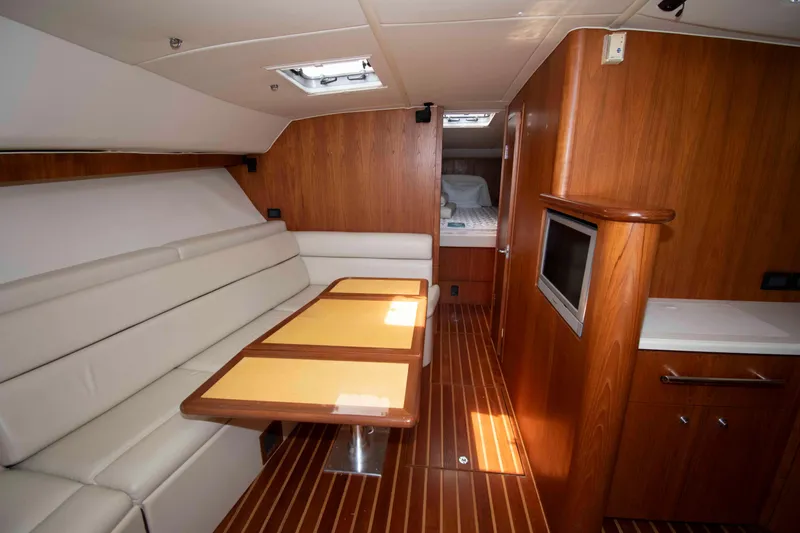 Slide: The Image of Luxurious interior of 2004 Tiara Yachts 4100 Open with wood finish and seating area. - 20