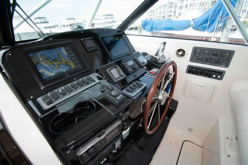 Slide: The Image of 2004 Tiara Yachts 4100 Open helm with navigation screens and controls. - 11