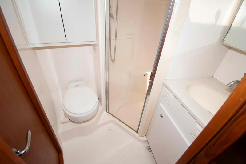 Slide: The Image of Bathroom interior of 2004 Tiara Yachts 4100 Open, featuring toilet, shower, and sink. - 26