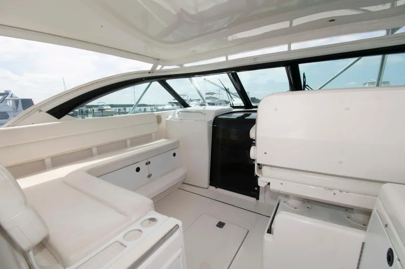 Slide: The Image of 2004 Tiara Yachts 4100 Open interior with white seating and helm station. - 6