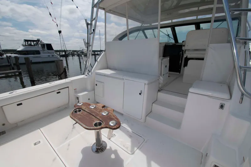 Slide: The Image of 2004 Tiara Yachts 4100 Open boat interior with seating and table, docked at marina. - 3
