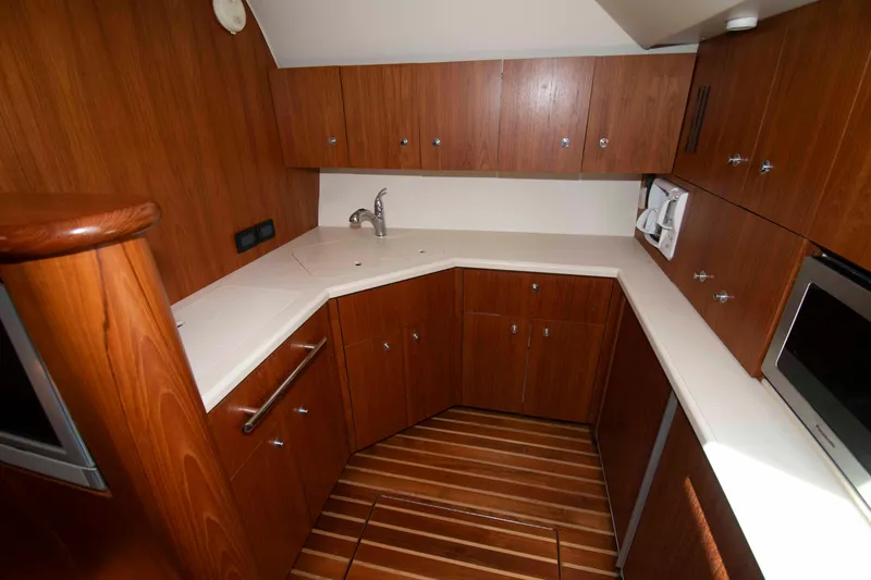 Slide: The Image of Luxurious 2004 Tiara Yachts 4100 Open galley with wood cabinetry and modern appliances. - 24