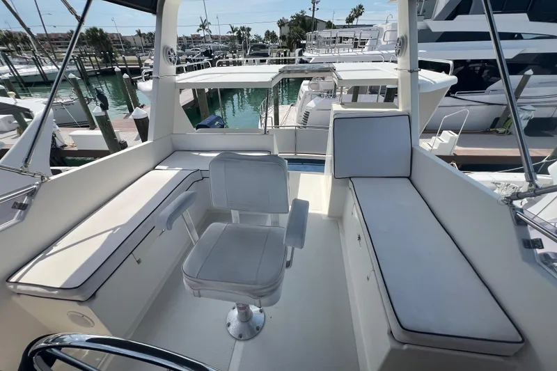 Slide: The Image of 2007 Heritage East 36 Sundeck Trawler interior with seating and marina view. - 6