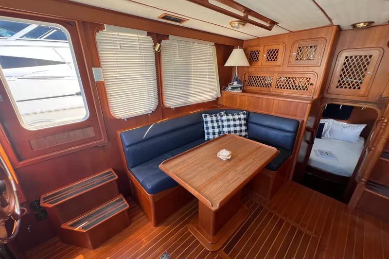 Slide: The Image of Interior of 2007 Heritage East 36 Sundeck Trawler with wood finish and cozy seating area. - 10