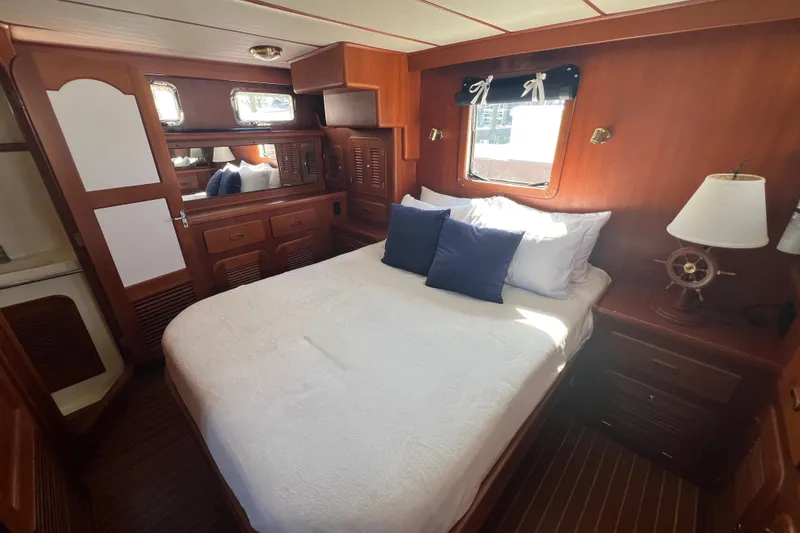 Slide: The Image of Cozy bedroom in 2007 Heritage East 36 Sundeck Trawler with wooden interior and nautical decor. - 17