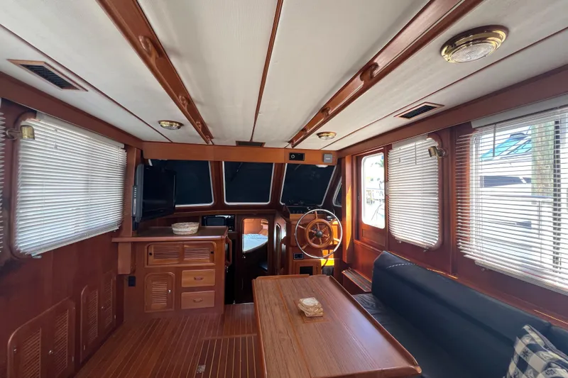 Slide: The Image of Interior of 2007 Heritage East 36 Sundeck Trawler with wooden furnishings and helm station. - 16