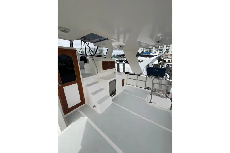 Slide: The Image of 2007 Heritage East 36 Sundeck Trawler, spacious deck with steps and wooden door. - 3