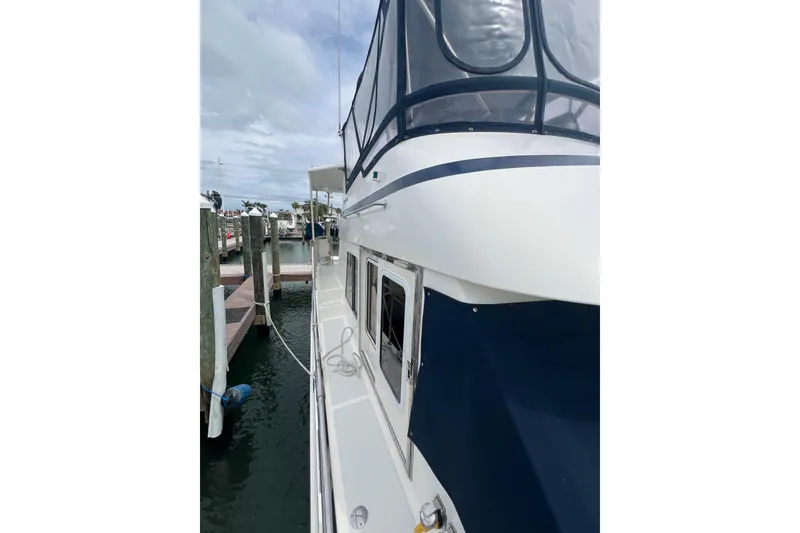 Slide: The Image of 2007 Heritage East 36 Sundeck Trawler docked at marina, side view. - 32