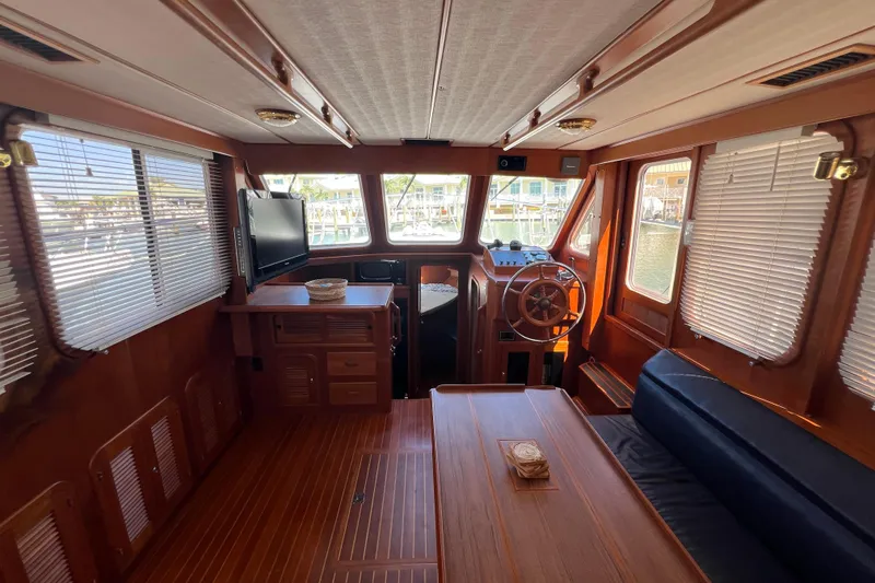 Slide: The Image of Interior of 2007 Heritage East 36 Sundeck Trawler with wood finish and helm station. - 12
