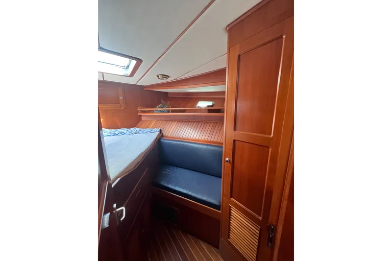 Slide: The Image of 2007 Heritage East 36 Sundeck Trawler cabin with wood paneling and blue seating. - 29