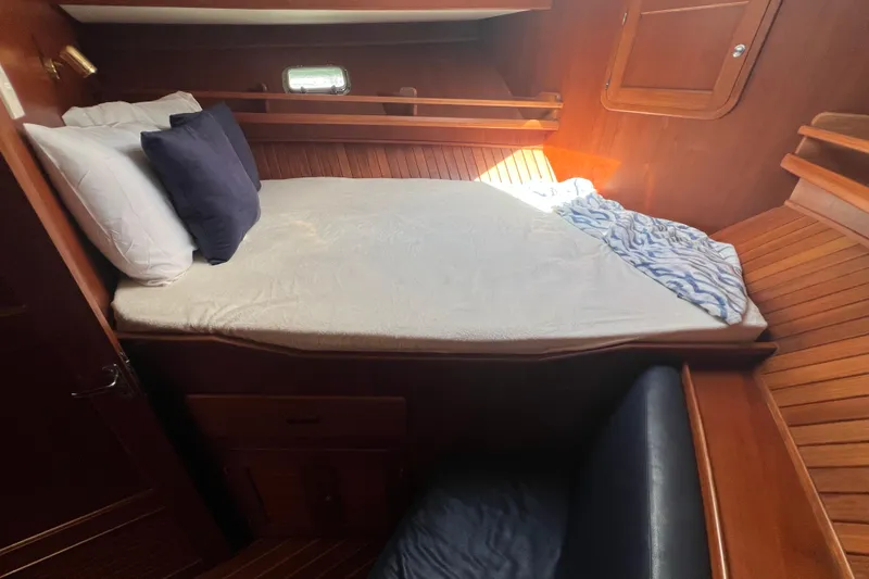 Slide: The Image of Cozy cabin interior of 2007 Heritage East 36 Sundeck Trawler with bed and wooden finish. - 30