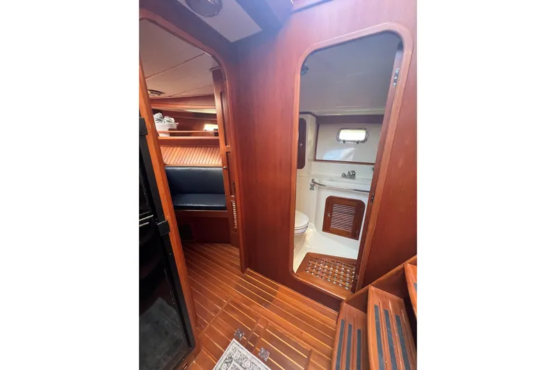 Slide: The Image of Interior of 2007 Heritage East 36 Sundeck Trawler with wooden finish and compact bathroom. - 26